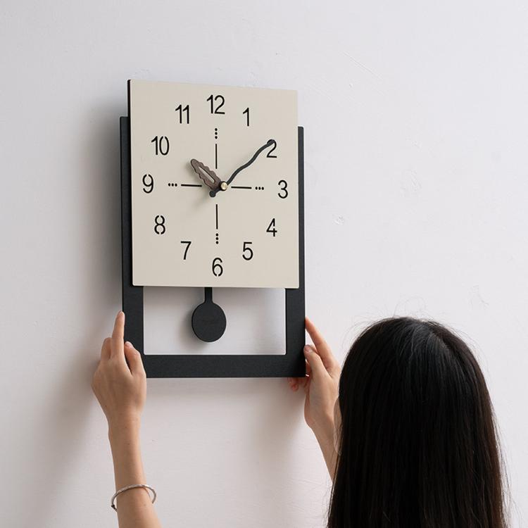 Cream white wall clock with minimalist dial, brown-accent hands, and dark wall mount
