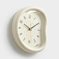 Cream oval wall clock with white face, minimalist hands and number markers