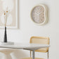 Beige-framed wall clock with light face, minimalist hands and number markers