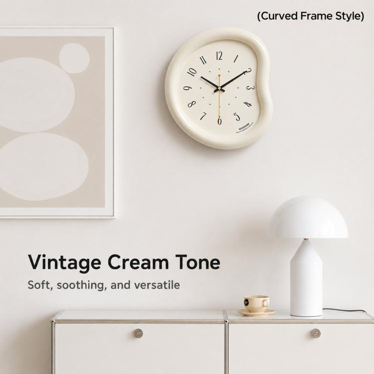 Cream curved-frame wall clock with black numbers and gold-tipped hands