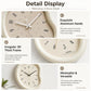 Cream wall clock close-up showing aluminum hands and an irregular thick frame