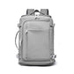 Light gray travel backpack with front panel pocket, side buckles, and top handle
