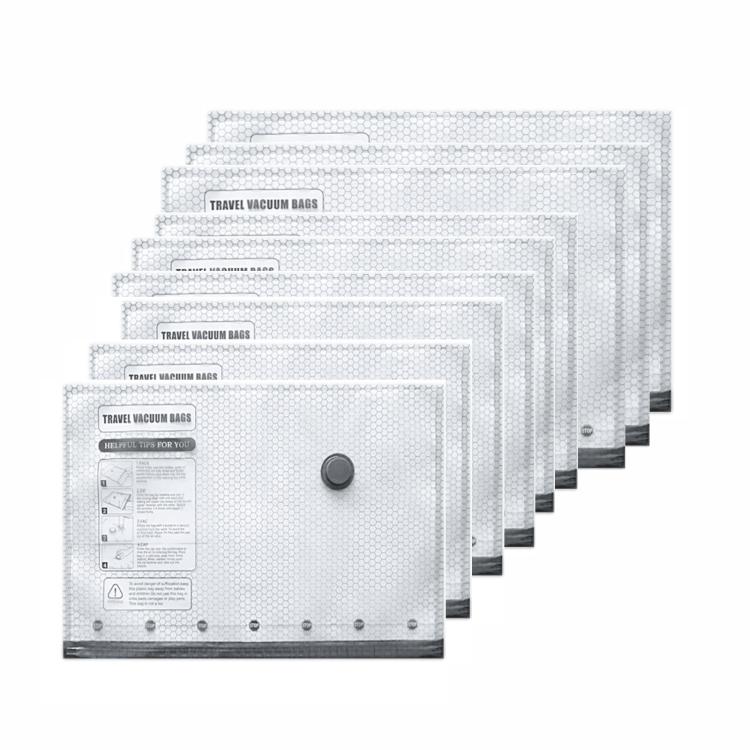 Stack of clear travel vacuum storage bags with round valve caps and instruction label
