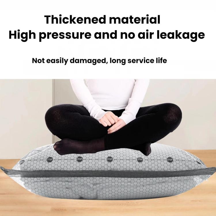 Grey vacuum compression bag with valve opening, lying flat on the floor for packing
