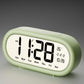 Light green digital alarm clock with large time, date, and temperature display icons