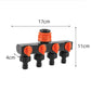 4-way water tap splitter with orange on-off valves on a black manifold and four outlet ports
