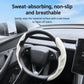 Light gray steering wheel cover with textured grip and molded center