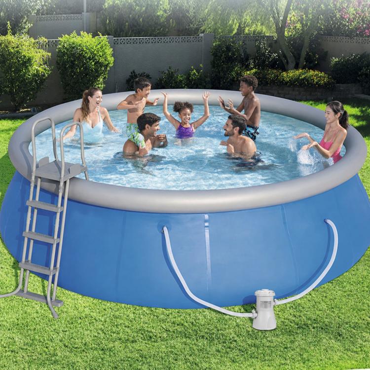 Pool filter pump placed beside an inflatable swimming pool with hose connected