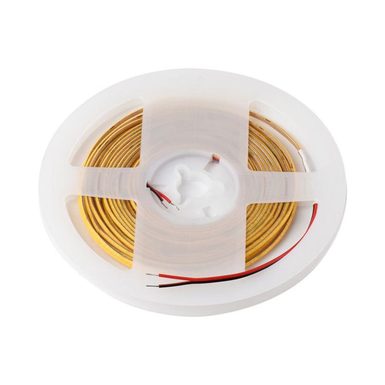 Spool of warm white COB LED light strip with exposed wires and red leads