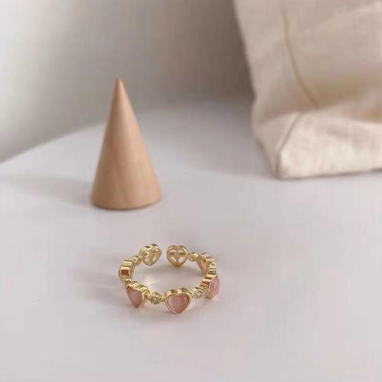 Gold-tone open adjustable heart ring with pink stones and small crystal accents