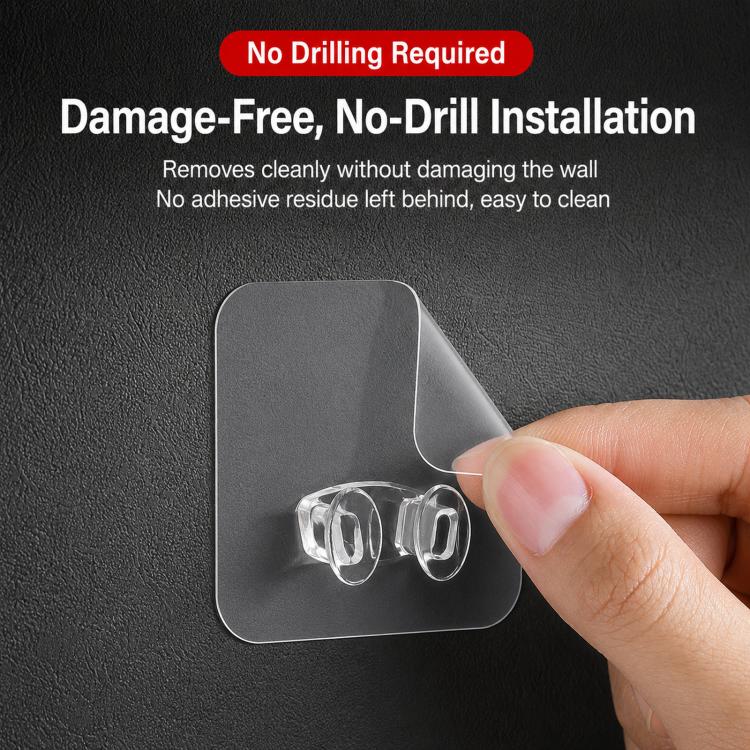 Transparent no-drill adhesive hook on wall, hand pressing backing pad with clear clips