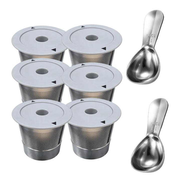 Set of stainless steel K-cup pods with gray lids and two metal spoons
