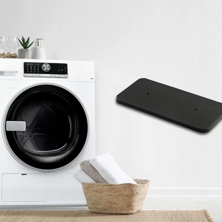Black rectangular foam dryer filter lying near a tumble dryer
