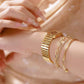 Gold-tone women's vintage watch with metal bracelet and dark blue square dial