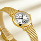 Close-up gold-tone small round watch with ribbed expansion band and white dial