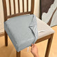 Gray velvet chair seat cushion cover draped over dining chair, showing side flap