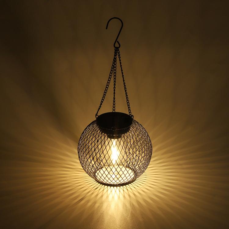 Warm-lit black metal mesh globe hanging lantern with hanging chain
