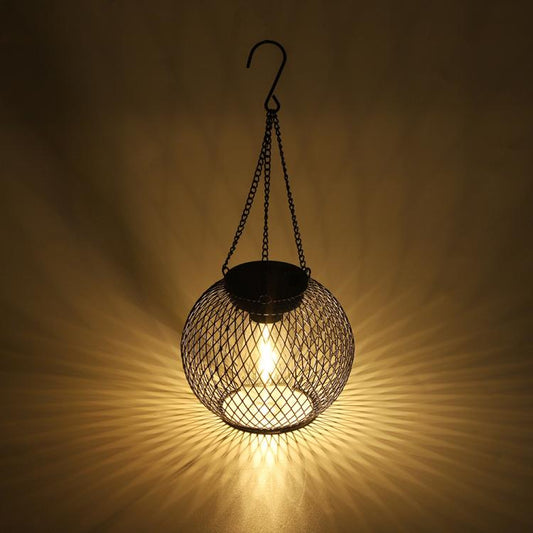 Warm-lit black metal mesh globe hanging lantern with hanging chain