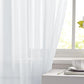 White sheer curtain fabric panel with vertical folds and translucent light