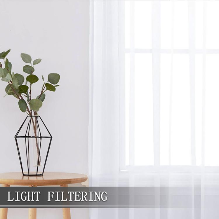 White sheer rod pocket curtain panel filtering daylight with smooth vertical drape