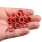 Red drain screw gasket washers in hand, small sealing rings with center holes