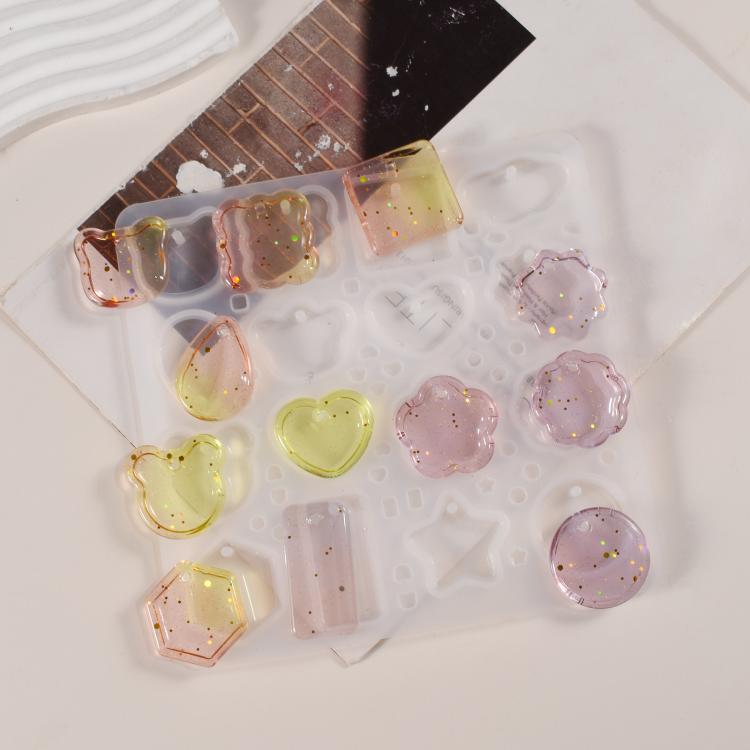 Finished resin pendants in assorted shapes on the silicone mold, with small holes for chains