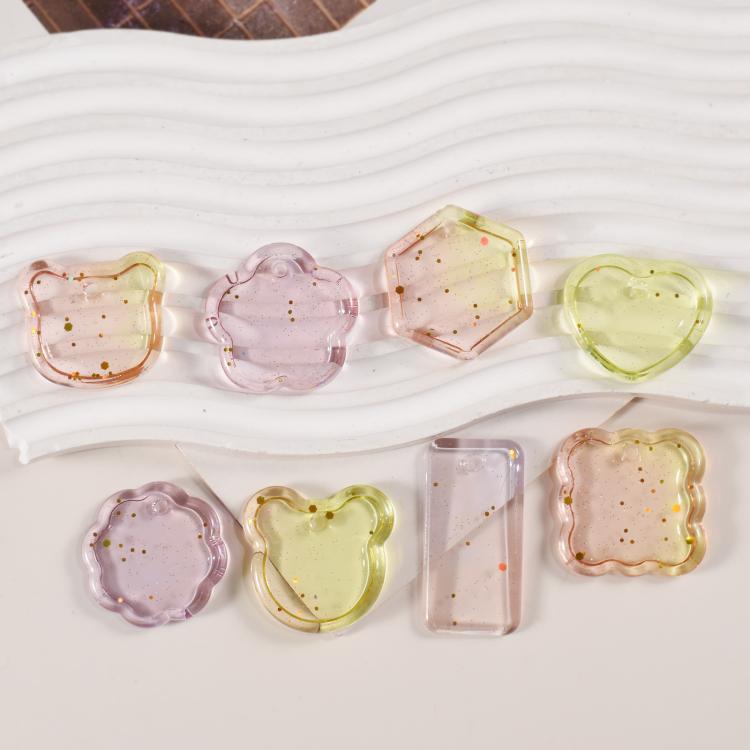 Assorted finished resin pendants in heart, flower, hexagon, rectangle, and star shapes