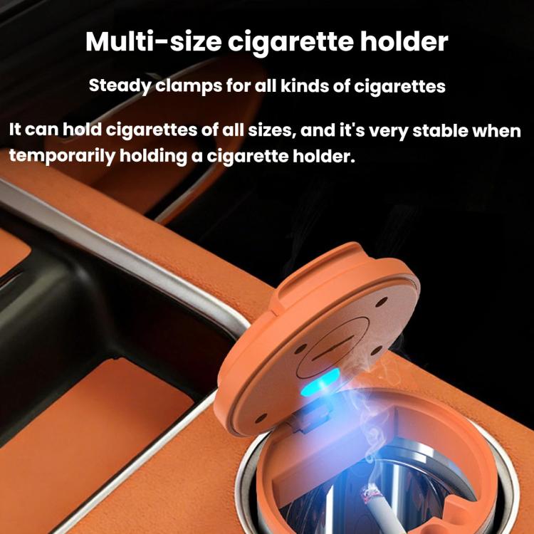 Orange metal car cigarette disposal can with LED glow, close-up on dashboard
