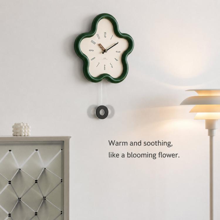 Flower-shaped wall clock with green frame and cream face, black hands; wall mounted.
