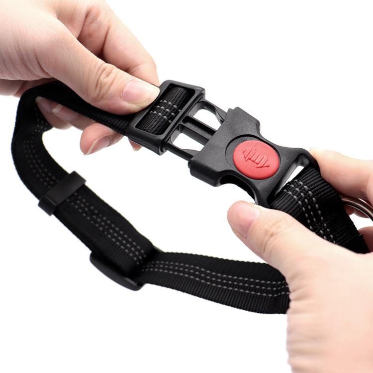 Close-up hands adjust black nylon safety lock buckle with red release button