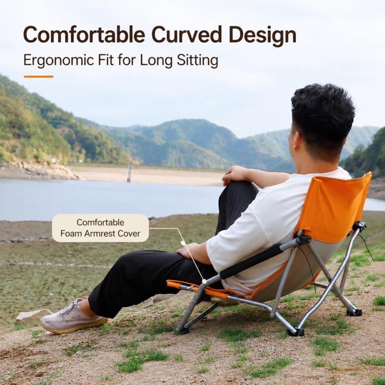 Orange folding beach chair with curved backrest and cushioned armrest covers