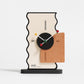 Geometric desk clock with cream back, black center dial, orange panel, and colored markers