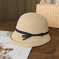 Cream straw cloche sun hat with dark ribbon bow on blue band, foldable style