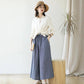 Straw cloche sun hat with ribbon bow and blue band, worn with a white blouse