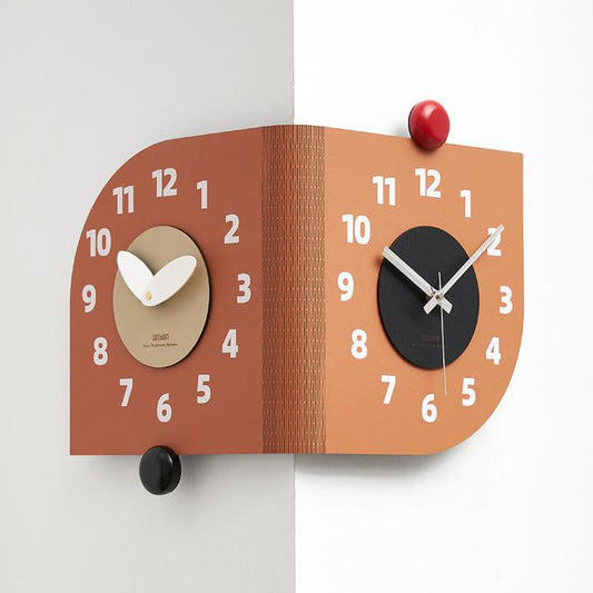 Orange dual-dial corner wall clock with white hands and red and black knobs