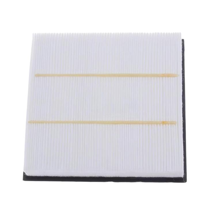 Cabin air filter with white pleated media and two yellow alignment strips