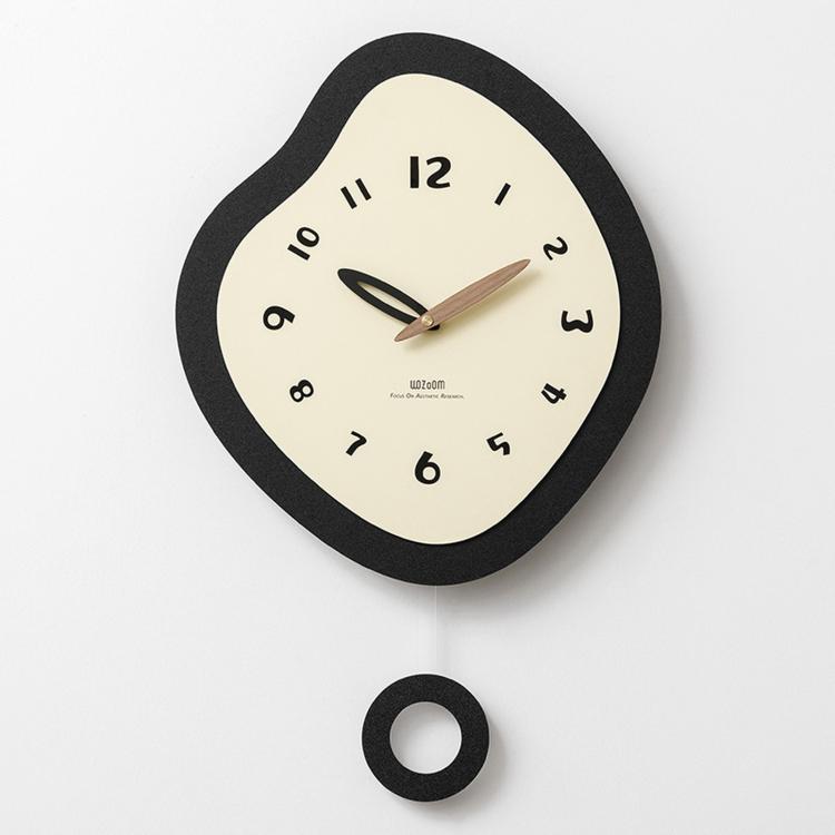 Irregular wall clock with black frame and cream dial, with mounting ring shown below.