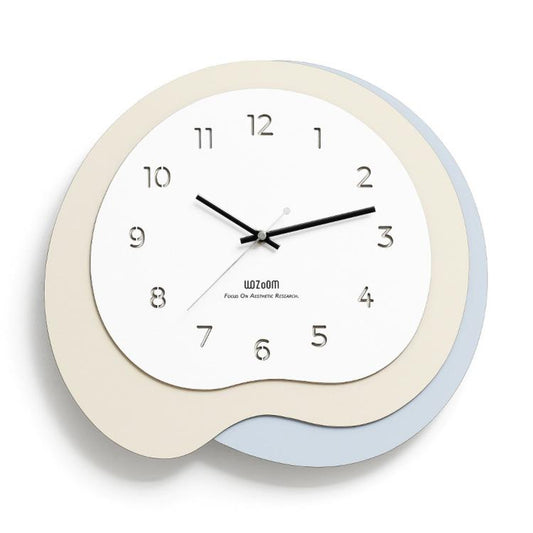 Irregular wall clock with beige frame and light blue outer ring, black hands and markers