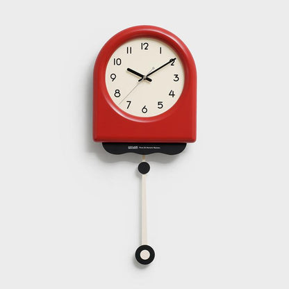 Red pendulum wall clock with cream dial, black hands, and hanging pendulum weight.