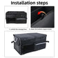 Black trunk storage box with raised bottom support panel and side carry handles