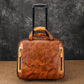 Brown leather rolling briefcase with orange trim and upright pull handle