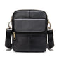 Black leather crossbody bag with front flap panel, top zip closure, adjustable shoulder strap