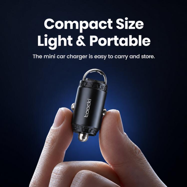 Black USB-C car charger held in hand, compact pull-ring design