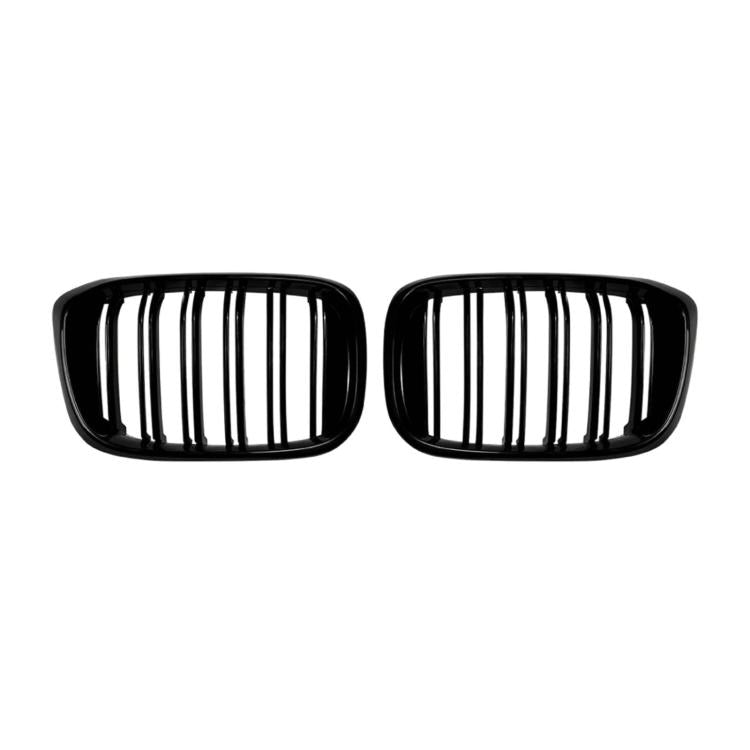 Pair of black oval grille inserts with vertical slat openings, front view