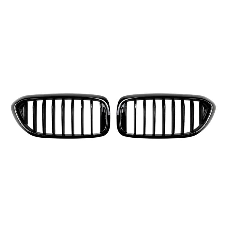 Pair of black front grille inserts with vertical slat bars, oval housing