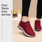 Red fleece-lined slip-on winter boots with textured sole, worn by model