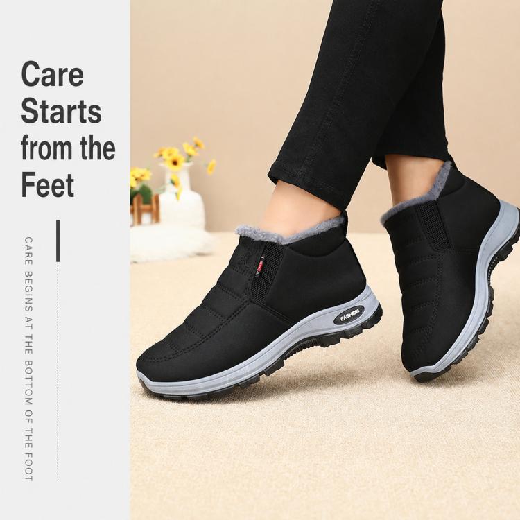 Black fleece-lined slip-on winter boots with textured sole, worn by model