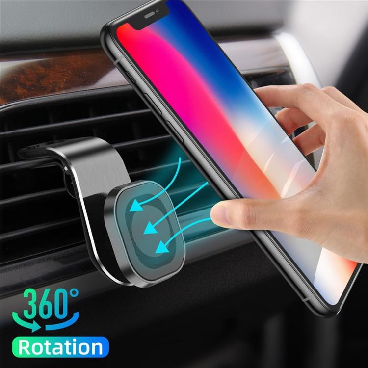 Car vent phone holder clamp with magnetic disk holding a smartphone