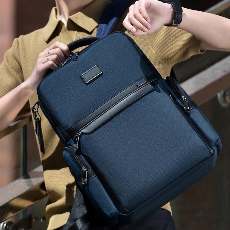 Blue laptop backpack with front zip pocket, top handle, and adjustable shoulder straps