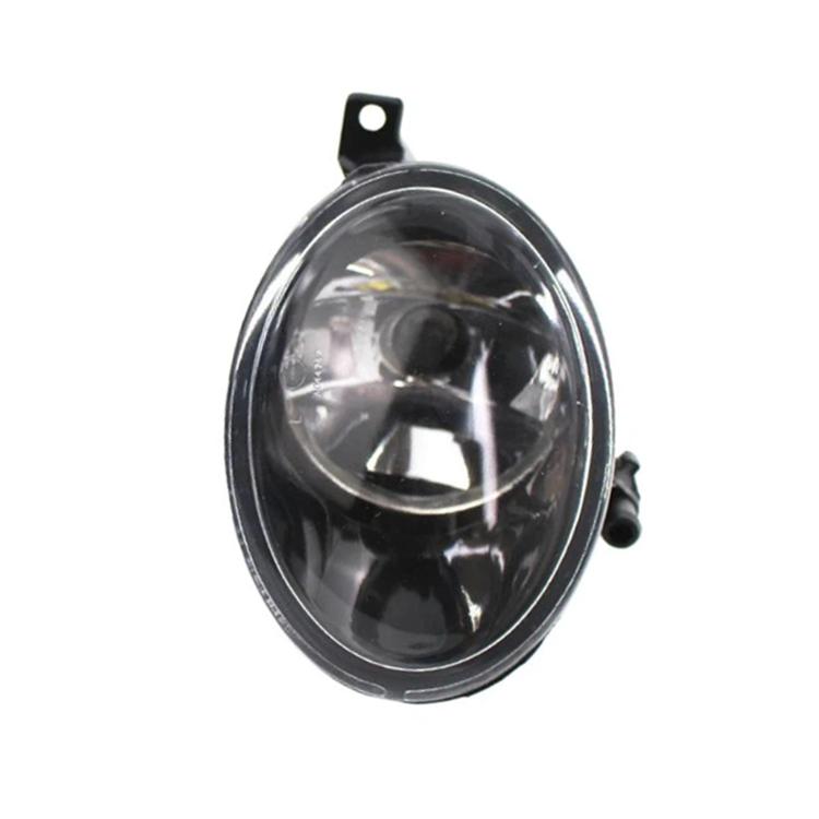 Front bumper fog light with clear lens and black housing, angled close-up